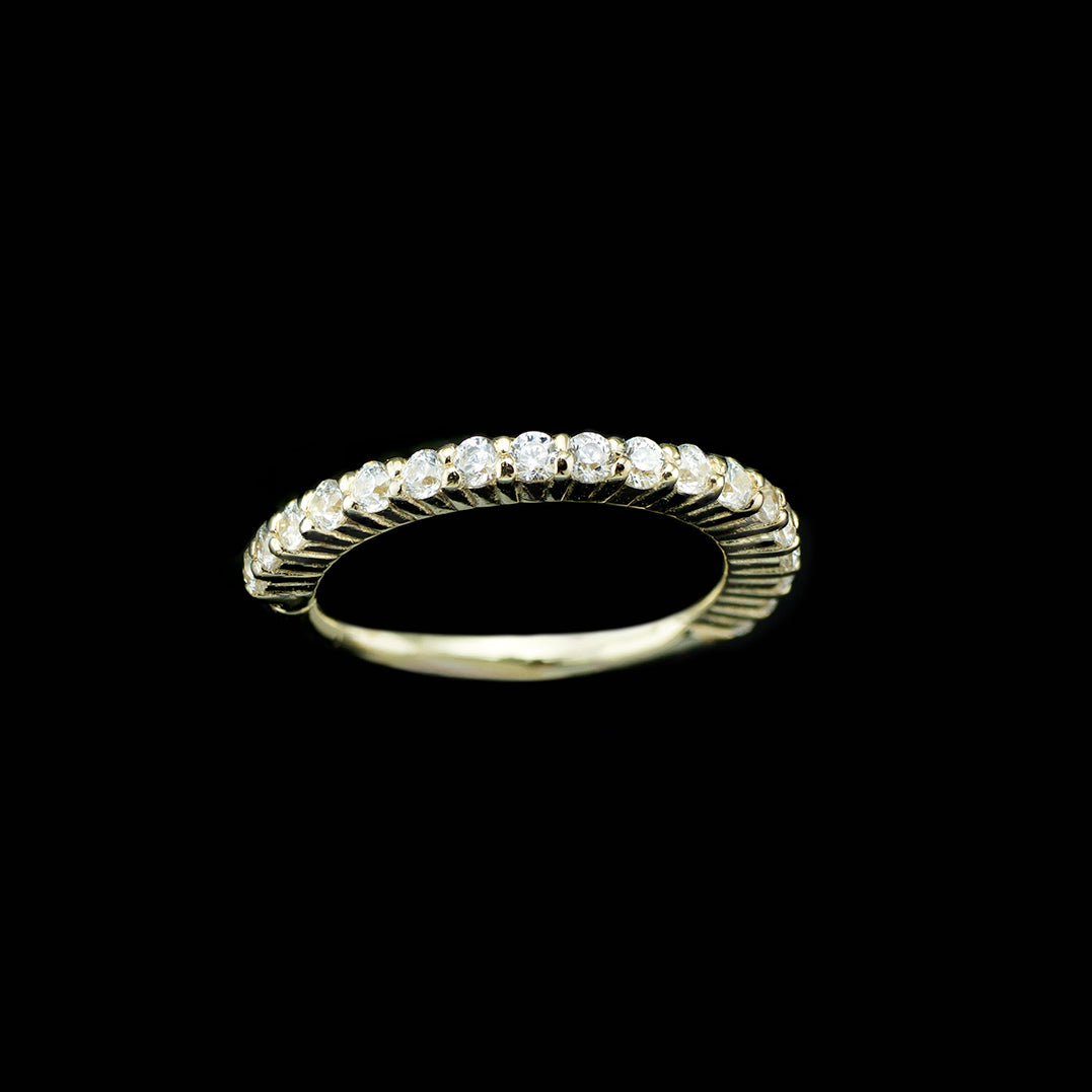 Yellow god ring with white cubic zirconia set throughout. The gemstones on this ring face outward, making it a good piece for helix, conch, and earlobes.
