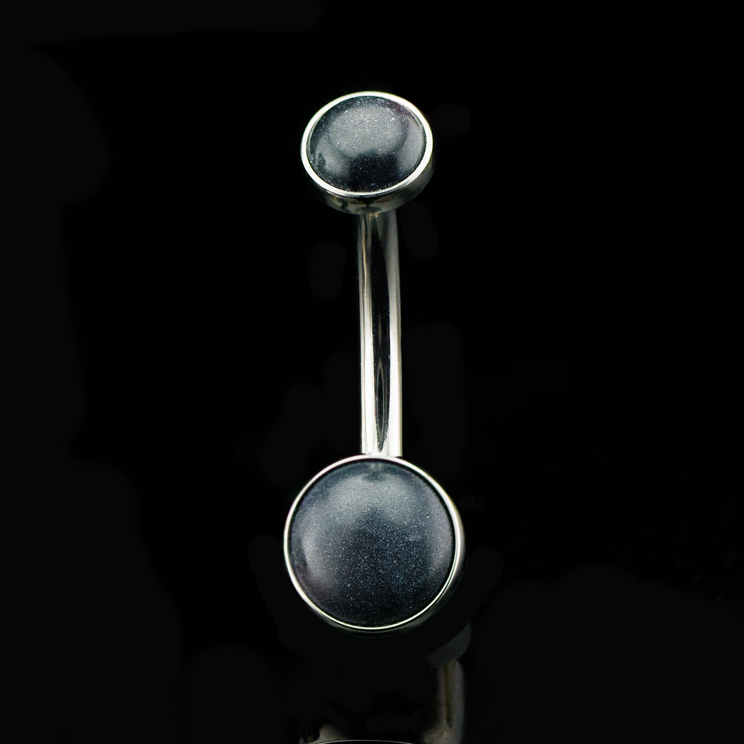 Navel curve with one opaque black gem on the top and one on the bottom.