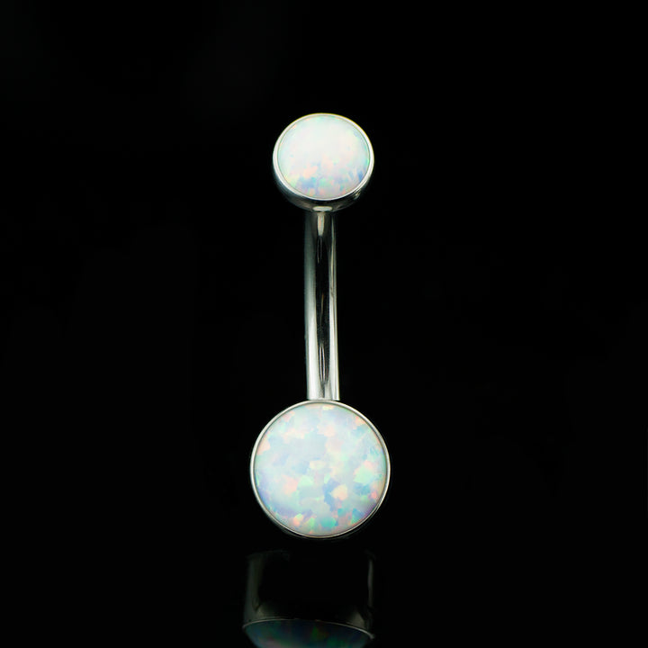 Navel curve with a round white opal at the top and bottom on a black background.
