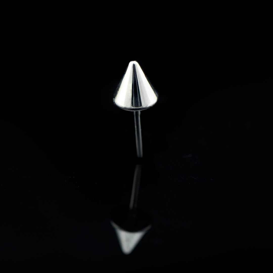 A silver color piece of body jewelry shaped like a cone/ spike set on a black background.