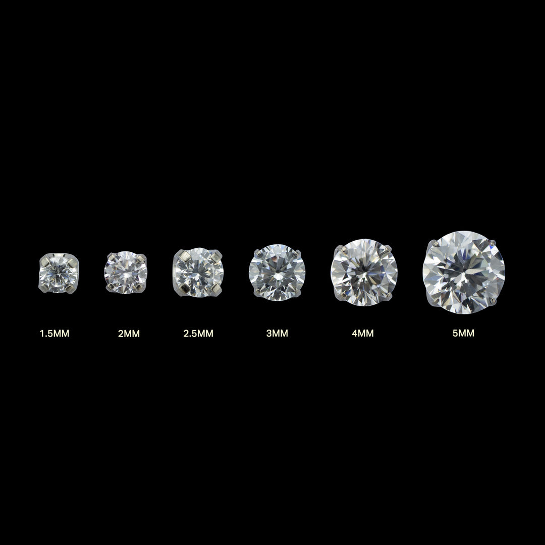 6 pieces of implant grade titanium body jewelry. Shown from left to right in ascending sizes. Each piece is a solitaire white cubic zirconia set in four prongs.  
Sizes listed under each gem. From left to right: 1.5mm, 2mm, 2.5mm, 3mm, 4mm, 5mm