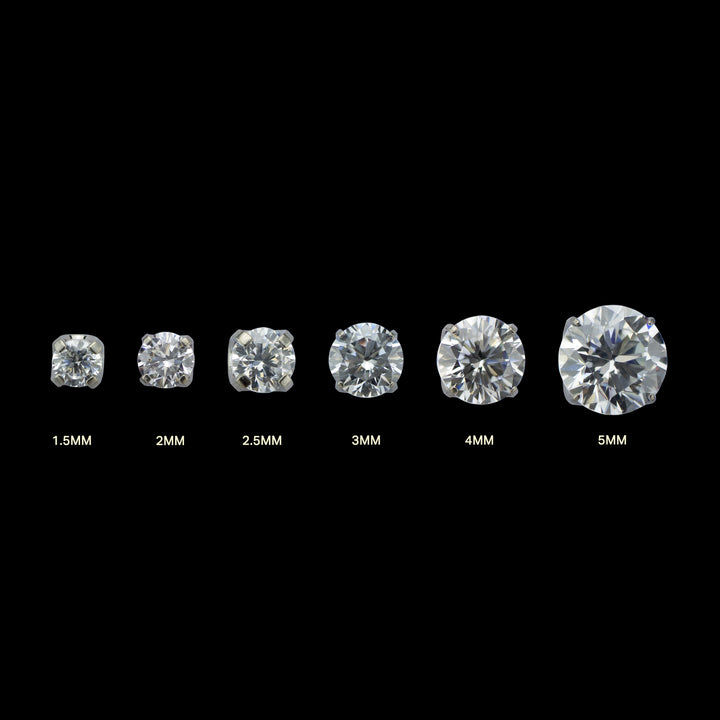 6 pieces of implant grade titanium body jewelry. Shown from left to right in ascending sizes. Each piece is a solitaire white cubic zirconia set in four prongs.  
Sizes listed under each gem. From left to right: 1.5mm, 2mm, 2.5mm, 3mm, 4mm, 5mm