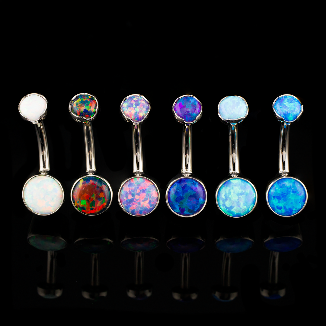 Six Cabochon Navel Curves in a row on a black background. Each with a different opal color
