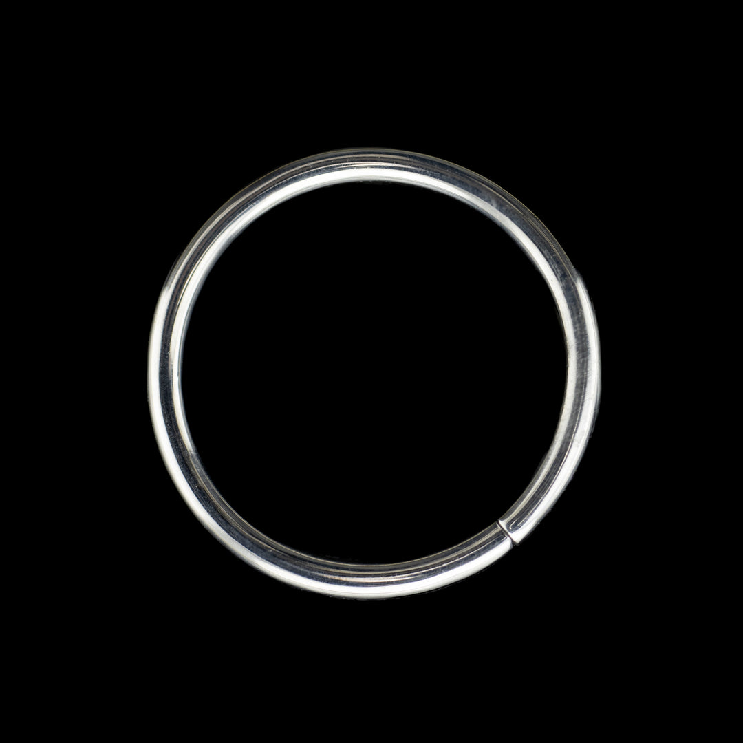 Solid white gold seamless hoop on a black background. A high polish rings for belly, navel, nostril, daith, cartilage, helix, rook, tragus, earlobe piercings. 