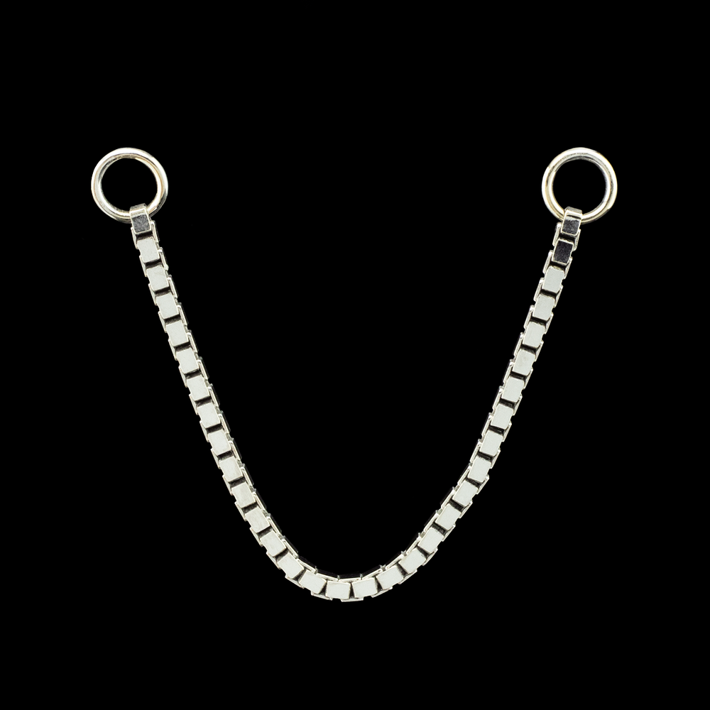 White gold box chain on a black background.