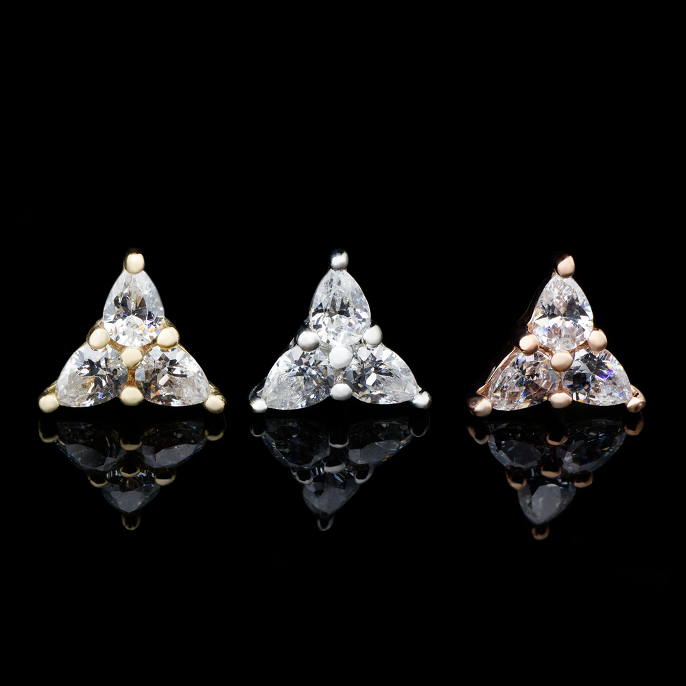 Three threadless ends on a black background, one in yellow gold, white gold, and rose gold. The 3 Little Pears end consists of three pear cut Swarovski cubic zirconia set in a triangular shape.