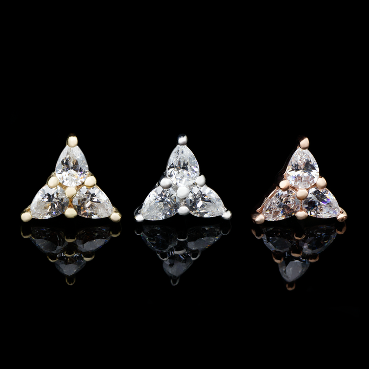 Three threadless ends on a black background, one in yellow gold, white gold, and rose gold. The 3 Little Pears end consists of three pear cut Swarovski cubic zirconia set in a triangular shape.