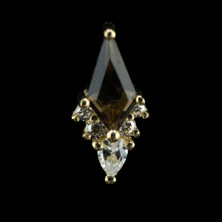  Front view of a piece of body jewelry that is a cluster of six gems set in white gold prongs. At the center is a large kite cut Smoky quartz with 5 cubic zirconia lining the bottom two sides of the cut kite garnet. the center and lowest cz is a smaller pear cut white cz facing downwards. there are two smaller round cut white czs on either side of the pear cut cz. 