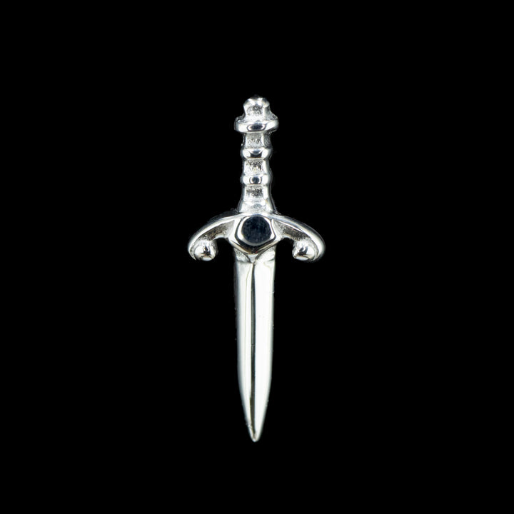 A white gold piece of jewelry that is a dagger with a decorative hilt.  