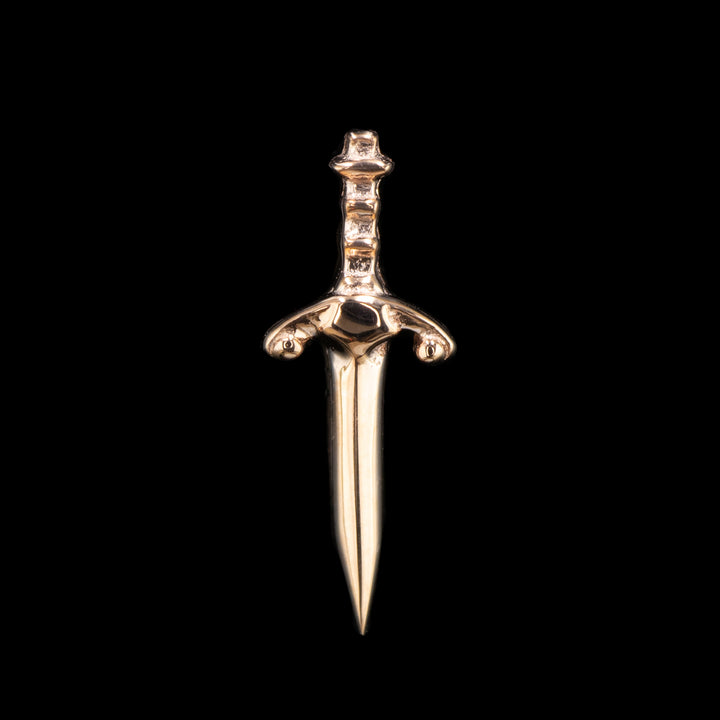 A rose gold piece of jewelry that is a dagger with a decorative hilt.  