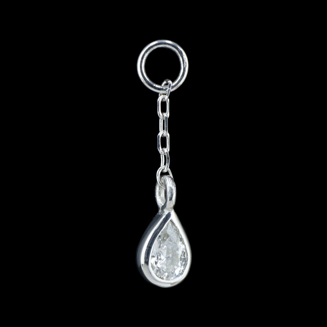 a white gold body chain charm on a black background. The piece is a length of cable chain attached to a jump ring with a bezel set pear Cubic Zirconia on the end.