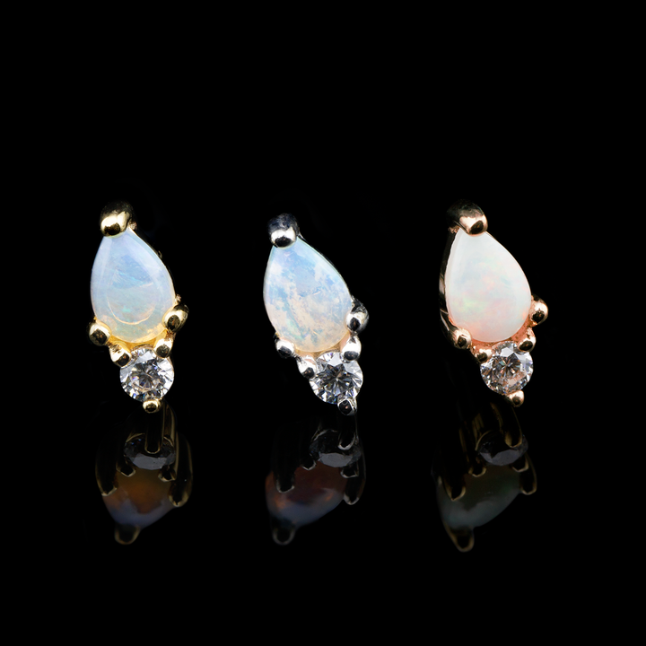 Three daydream ends from Buddha Jewelry on a black baclground. This design consists of a pear shaped genuine opal accented by a small cz at the bottom.