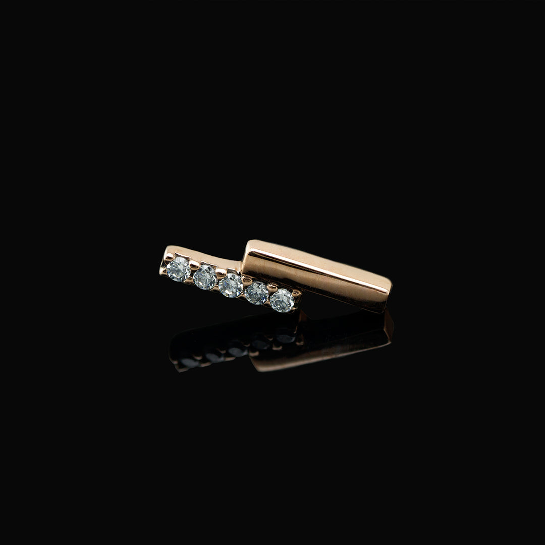 Rose gold piece of body jewelry consisting of two offset bars, one set with 5 white CZs. 