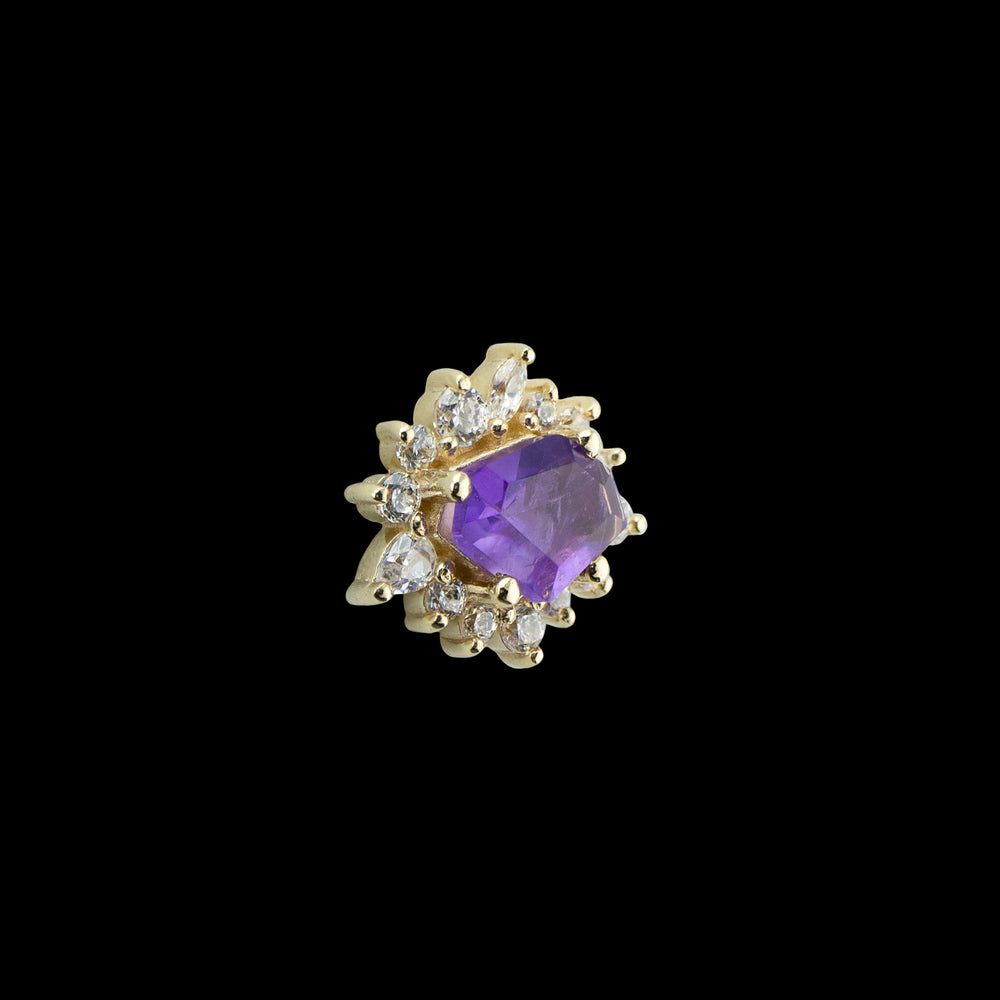 Side view of a piece of body jewelry. At it's center there is a freeform cut of amethyst surrounded by 12 varying sizes of round cut CZ, 1 marquise cut CZ, and one pear cut CZ. Set in 14 karat yellow gold. 