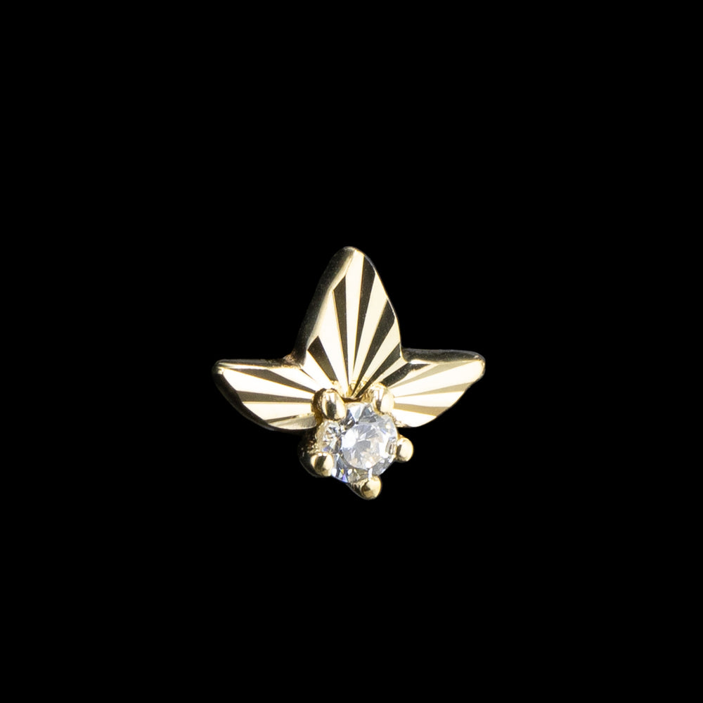 A yellow gold threadless end with laser cut texture and sparkling CZ set in the bottom center.