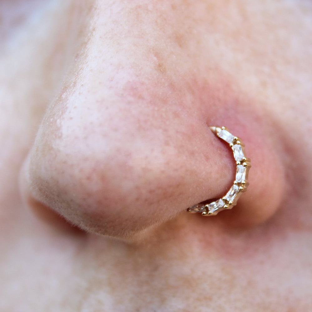 Close up of a nostril piercing wearing a Loved Clicker.