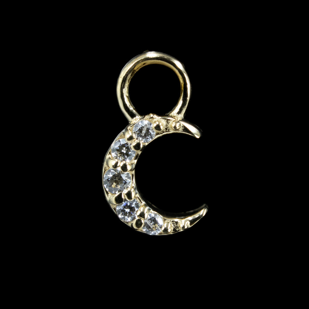 A yellow gold crescent moon shaped body jewelry charm with 5 Swarovski Cubic Zirconia.