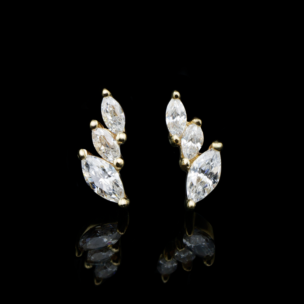Two yellow gold Multiplicity ends from Buddha Jewelry on a black background. One is the left multiplicity and one is the right. The ends are mirrored in the photo. 