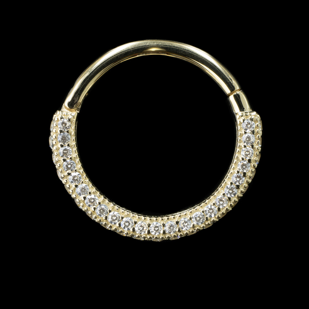 Front view of a yellow gold hinge ring on a black background. This piece is reversable with Swarovski cubic zirconia on the front, back and bottom of the ring. There are 62 Swarovski crystals set in prongs with milgrain texture surrounding them. 