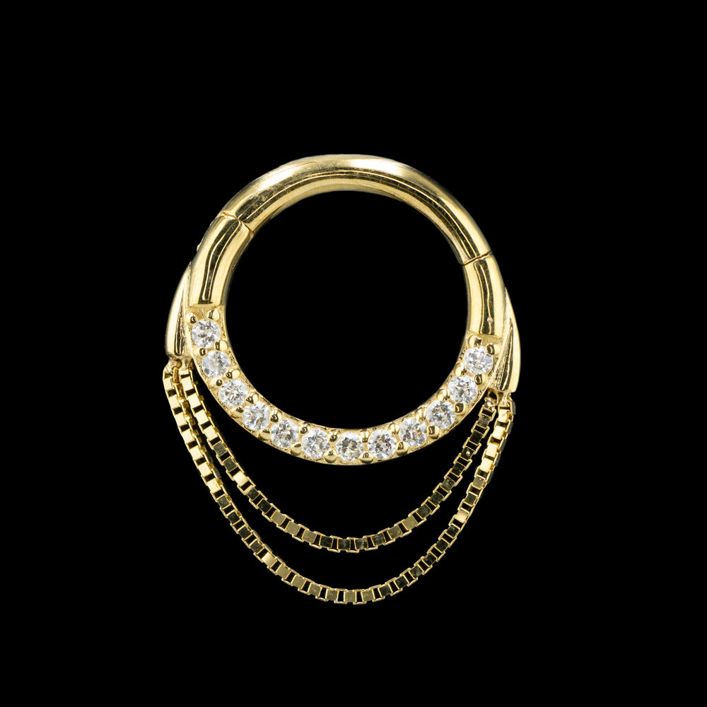 Yellow gold Tempeste Clicker on a black background.