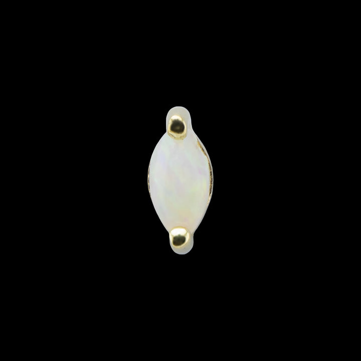 A yellow gold piece of body jewelry on a solid black background. This piece is a marquise white opal set in 2 yellow gold prongs at either end.