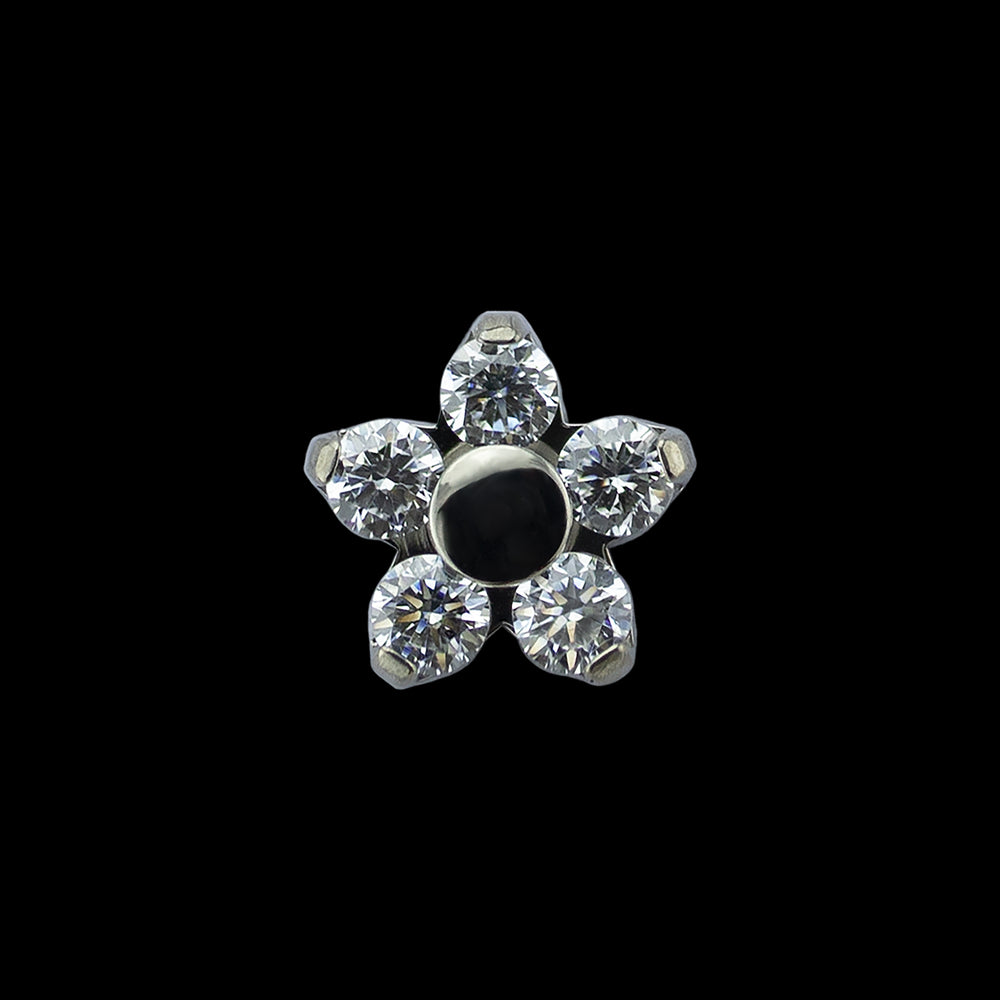 A titanium Flower end from Anatometal on a black background. 5 white cubic zirconia set in prongs around a titanium circular center.