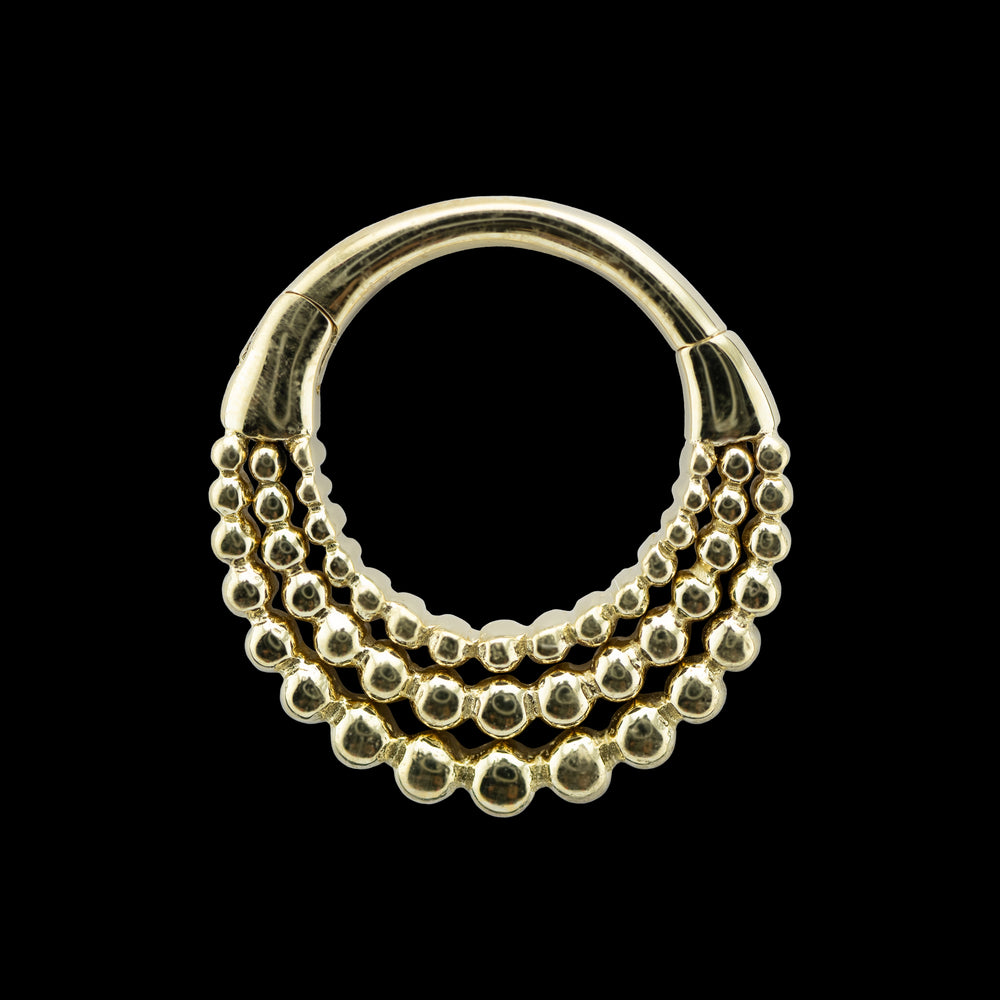 Yellow gold Fame Hinge ring on a black background