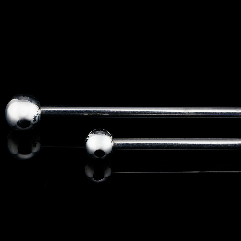 Two push pin industrial barbells with beads on a black background