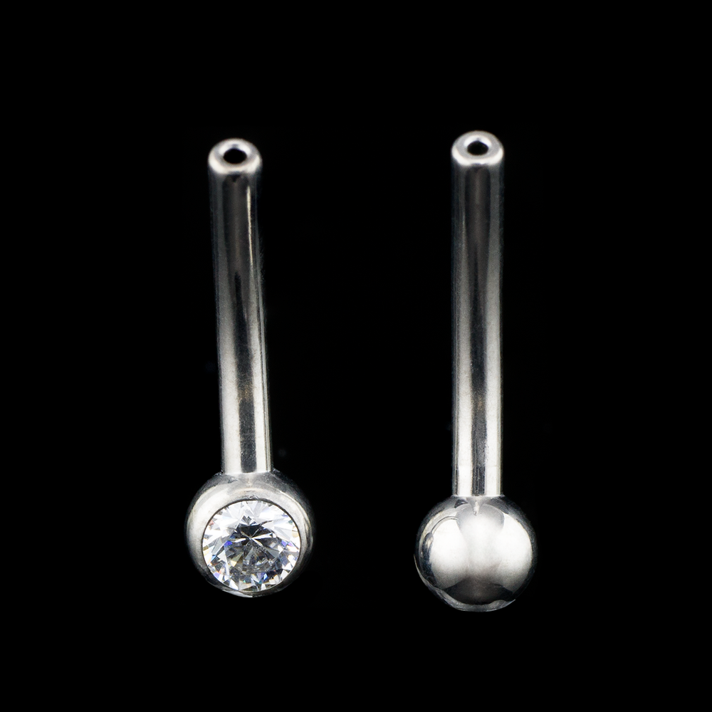 Two push pin titanium curved barbell shafts with not threadless end on a black background. One curve has a plain bead on the bottom and the other has a small cz gem ball on the bottom.