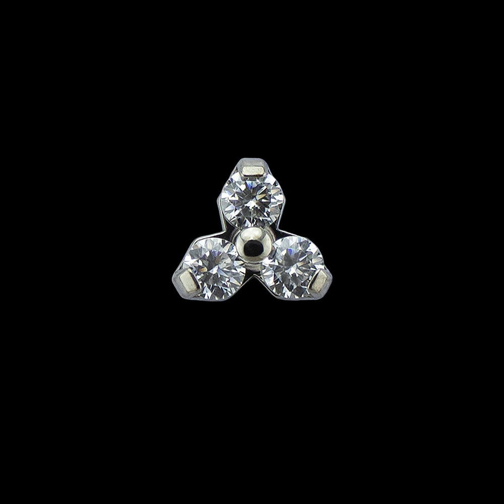 A titanium trinity end with white CZs on a black background. The trinity end is made up of three small cubic zirconia set in prongs and arranged in a triangular shape