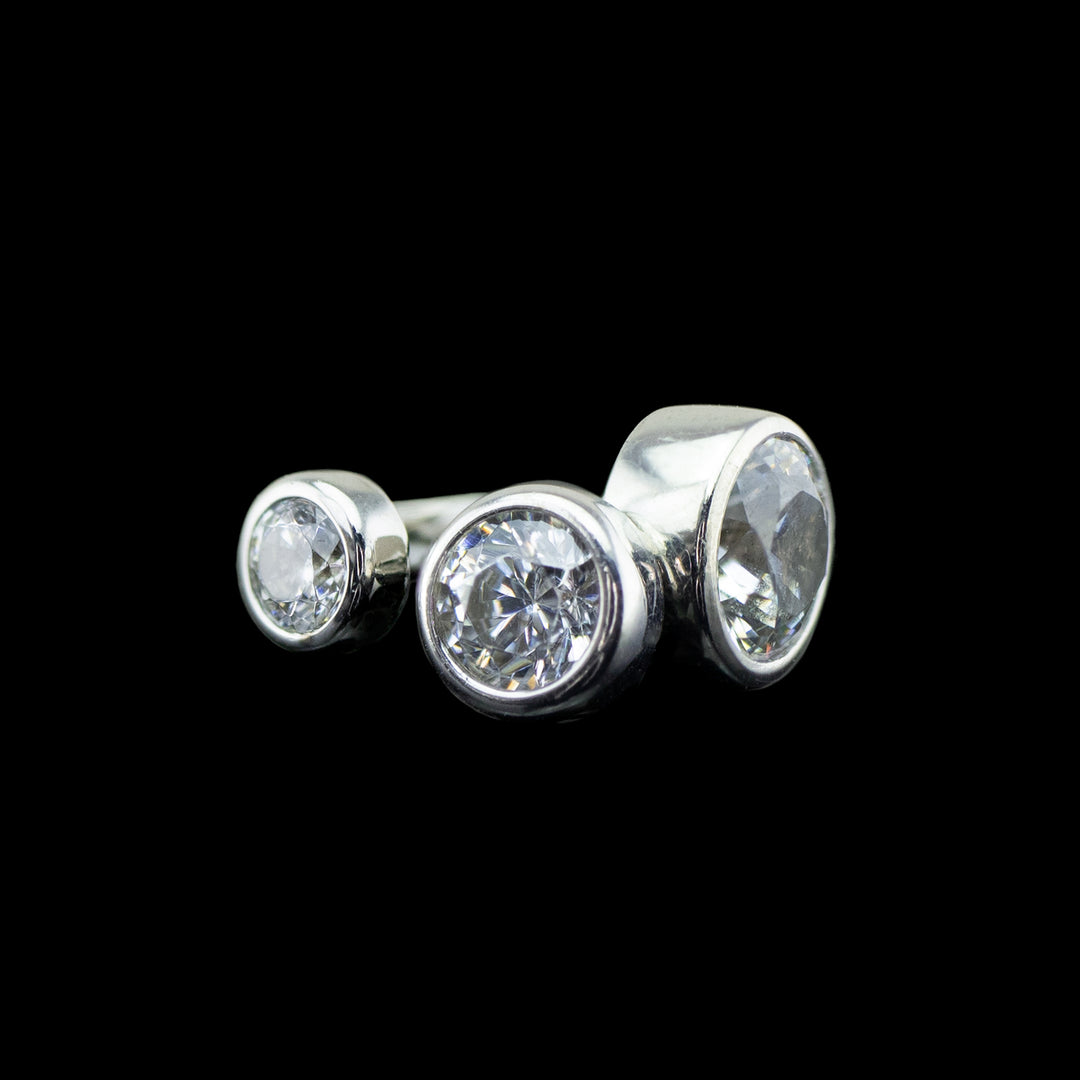 3 varying sizes of cubic zirconia set in a white gold bezel. 