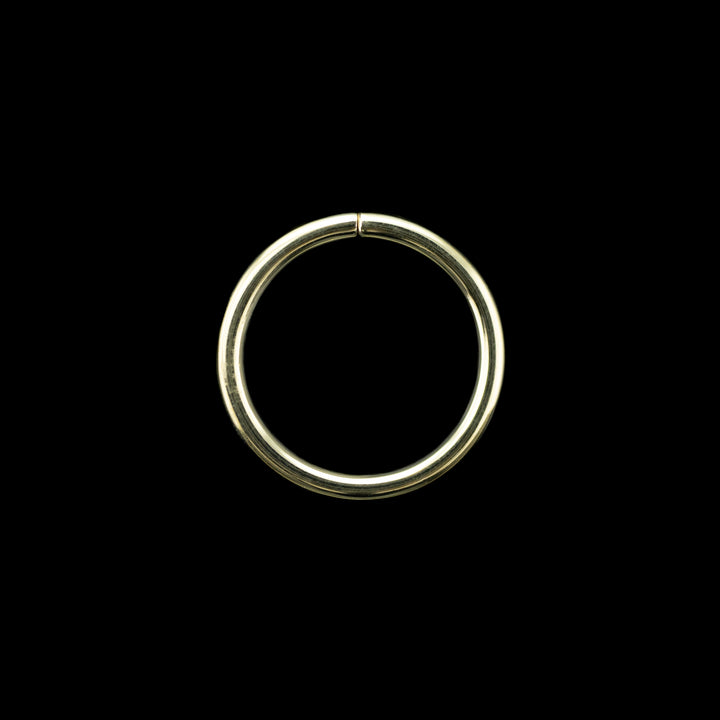 Solid yellow gold seamless hoop on a black background. A simple high polish ring for belly, navel, nostril, daith, cartilage, helix, rook, tragus, earlobe piercings. 